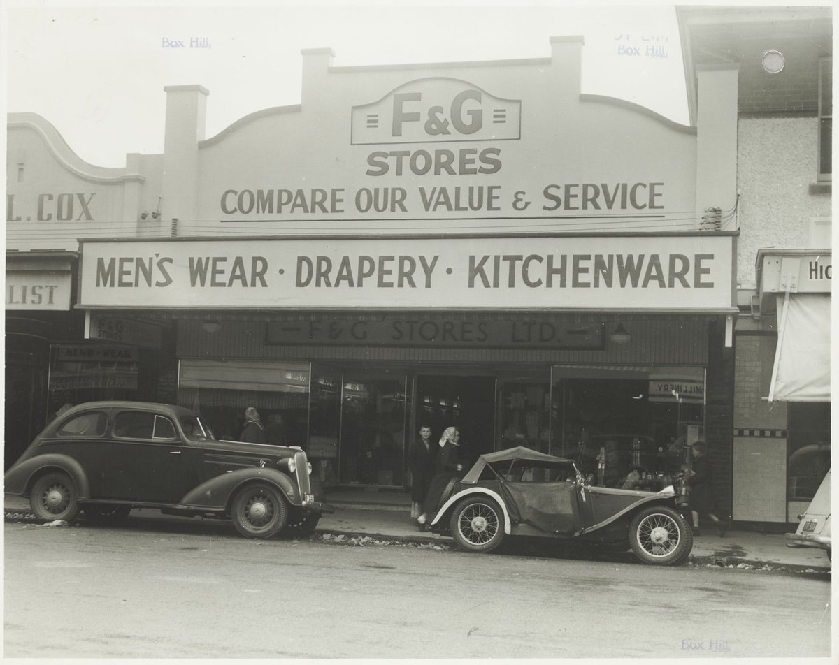 Street view with F & G Stores on parapet and vehicles parked at curb Coles Box Hill Store No. 44 (1930s)