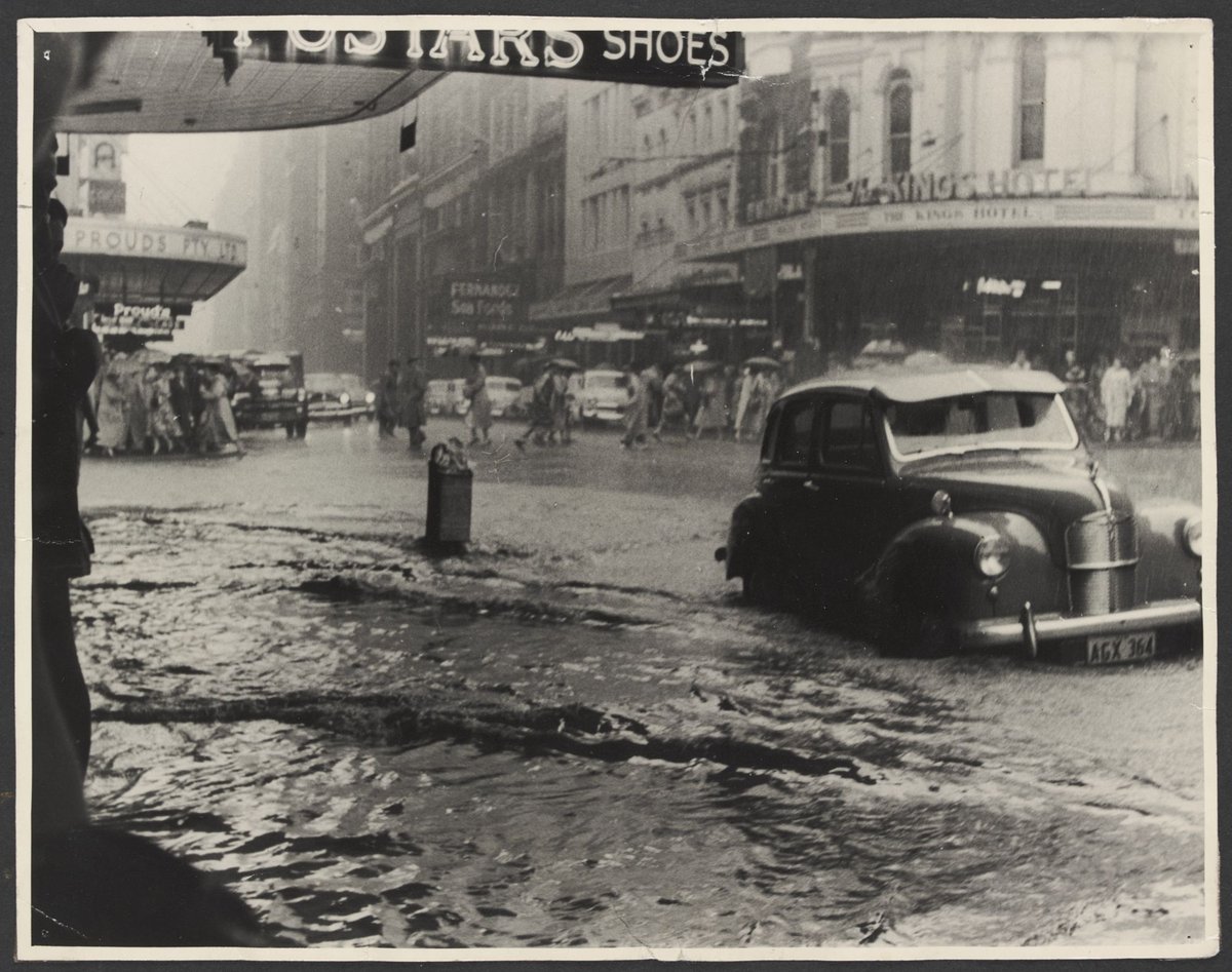 Flooding looking north over corner of Pitt and King Streets from front of Pitt Street Coles Variety Store No. 130, Melbourne City (1940–50)
