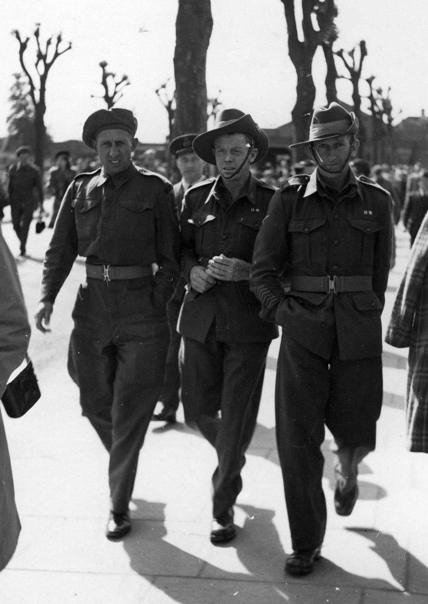 An English soldier, Pte. P. Coyne from Melbourne, Vic. and Pte. T. M. Dixon from Shepparton, Vic. at an English Derby meeting, 1945