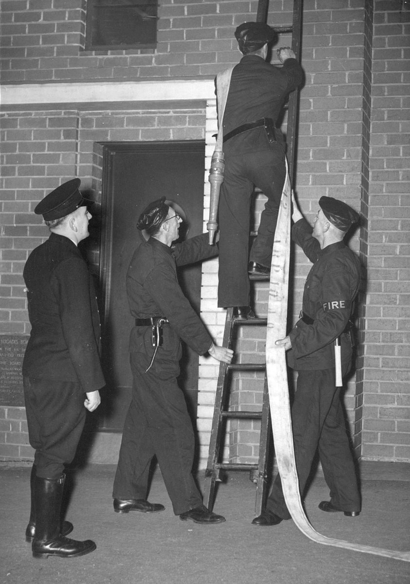 1st Class fireman H. Virtue supervises scaling ladder drill, Brunswick A.F.S. [i.e. Auxiliary Fire Service] (1939–45)