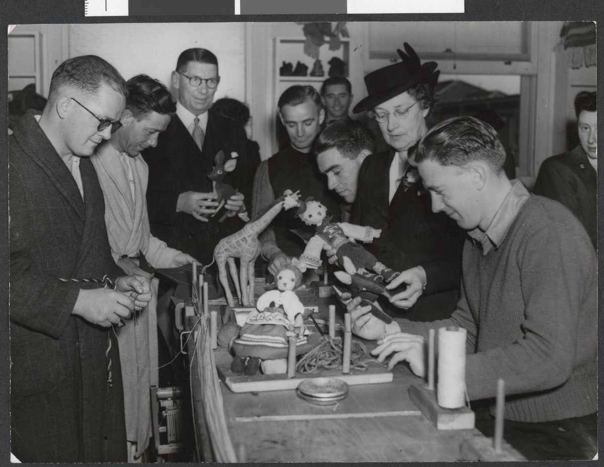 Lord Mayor Cr. Nettlefold receiving toys from soldier patients at Heidelberg for the Lord Mayor's Toys for Britain appeal (c. 1944)