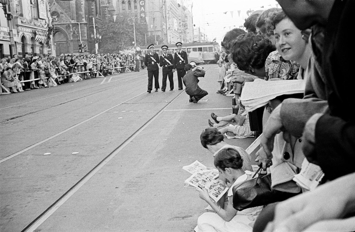 Queen's visit showing crowds at the corner of Flinders and Swanston Streets with barriers erected, Melbourne City (1954)