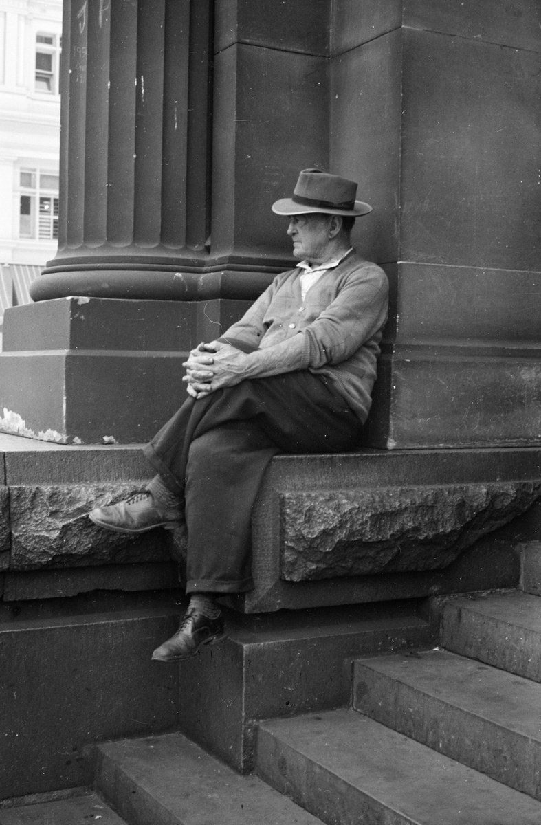 Men sitting on steps of the G.P.O., Melbourne, Melbourne City (1954)
