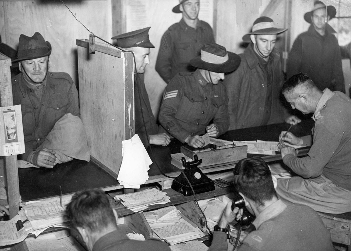 Dischargees signing papers at S.D.D. Royal Park, Parkville (c. 1944)