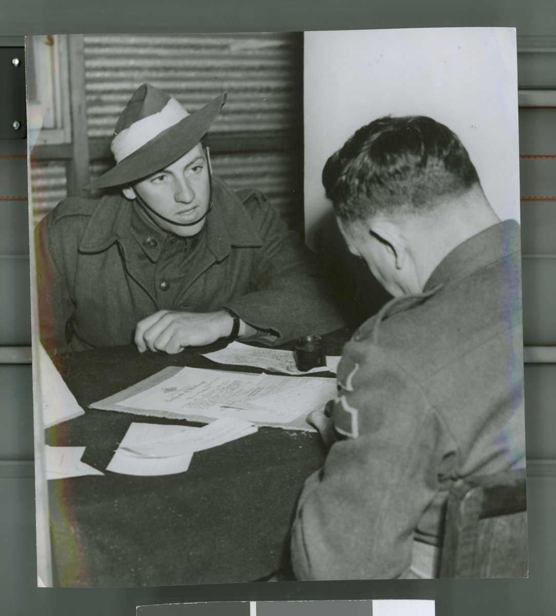 Pte Bernard Da Fonte being interviewed at re-habilitation section at G.D.D. Royal Park Camp, Parkville (c. 1945)