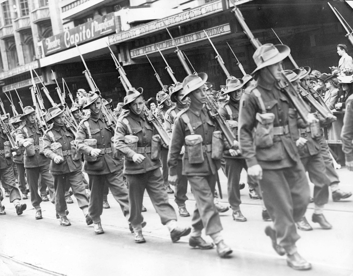4th and 15th Infantry Brigades march past Capital Theatre on Swanston Street, Melbourne City (c. 1944)