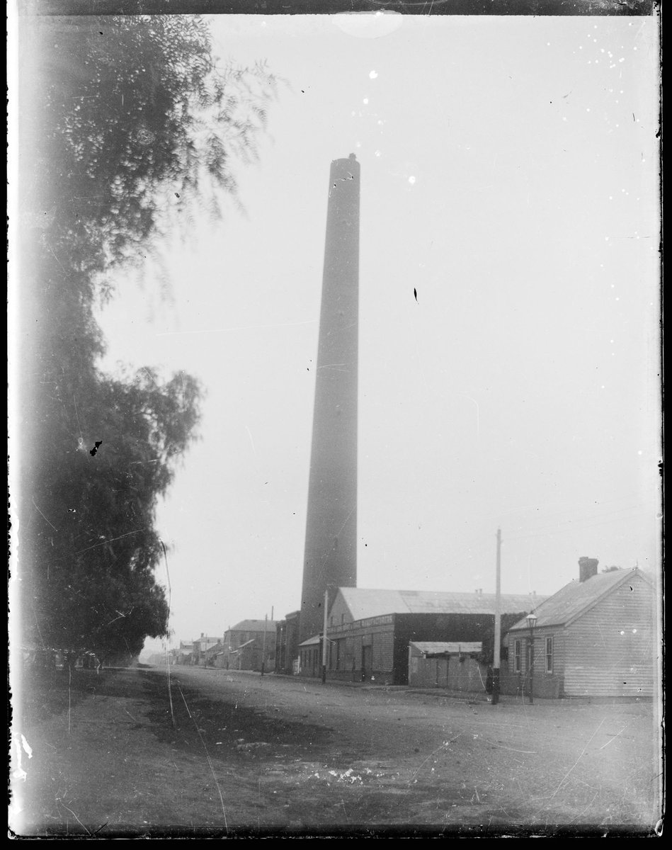 Street scene showing shot tower and commercial buildings or factories, possibly Clifton Hill (1905–10)