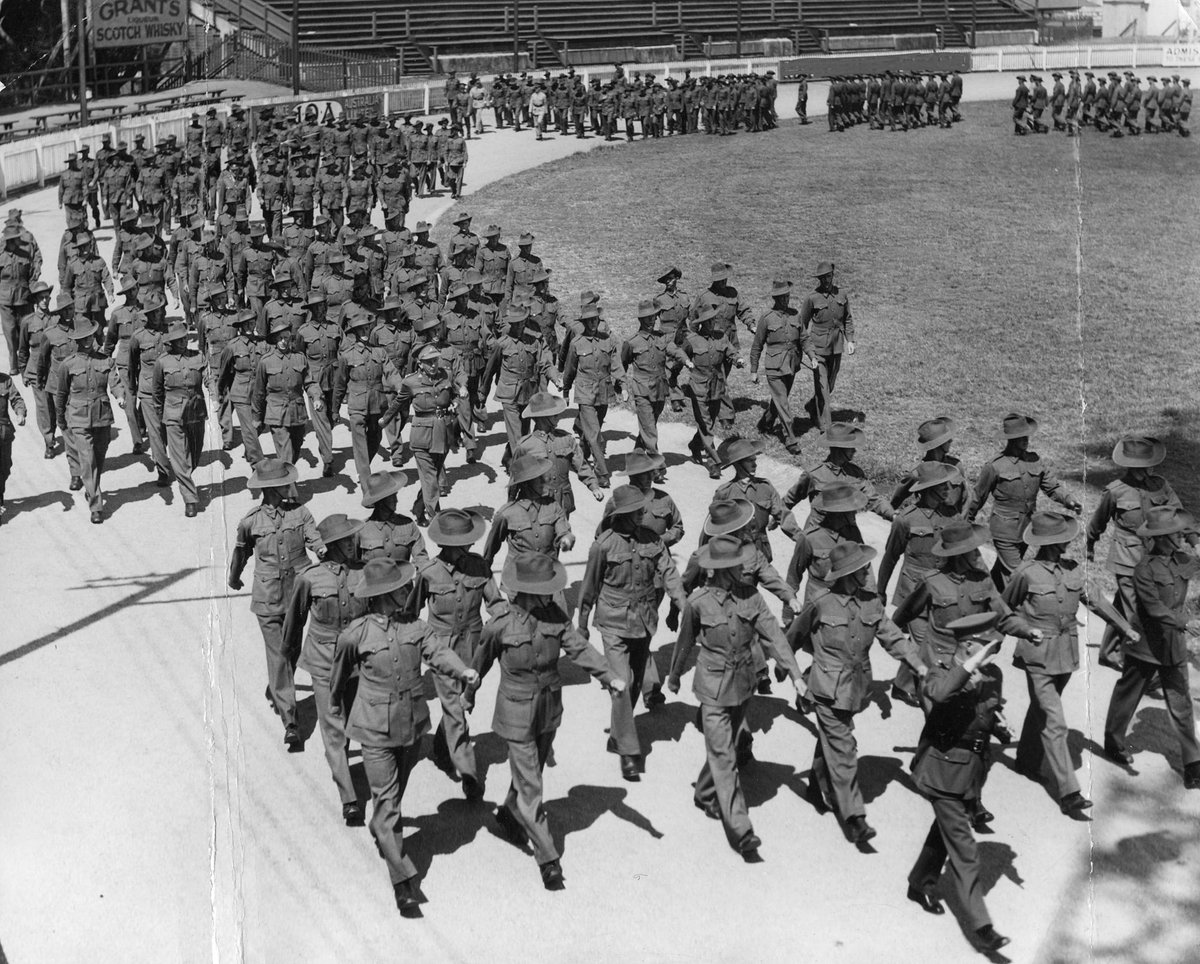 Troops from the 2nd. A.I.F. marching around racecourse at Royal Melbourne showgrounds, Flemington (c. 1939)