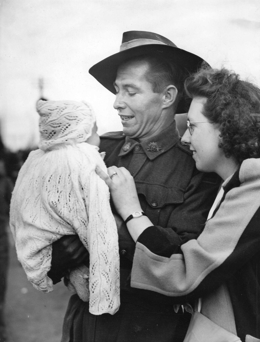 Pte. F. G. Jones, of Chelsea, at Royal Park, with wife and baby son after five years of service, Parkville (1942–48)