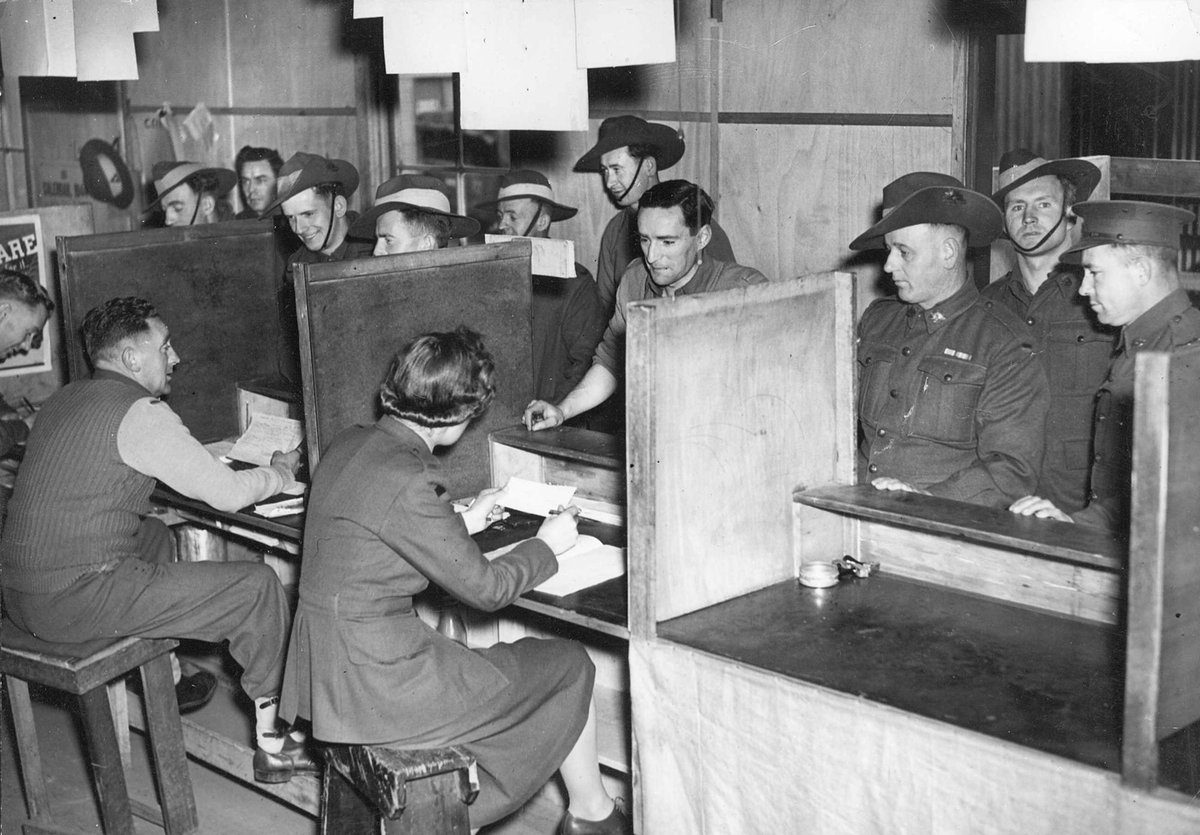 Dischargees signing papers at S.D.D. Royal Park, Parkville (c. 1944)