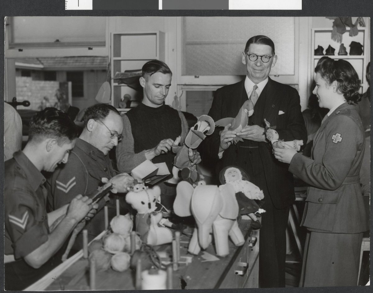 Lord Mayor Cr. Nettlefold, Sgt. L Annand and Cpl. W. S. Stonehouse inspecting toys from soldier patients at Heidelberg for the Lord Mayor's Toys for Britain appeal (c. 1944)