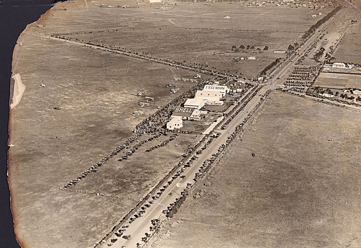 Aerial view of Essendon Airport with crowds and small aircraft, Essendon North (1920–40)