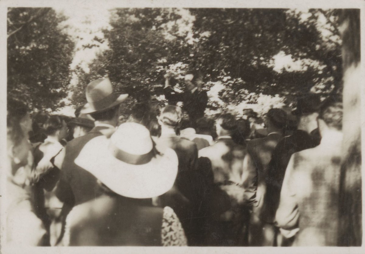 Group of people listening to man with raised fist, possibly on the Yarra Bank, Melbourne, Yarra River (1939–45)