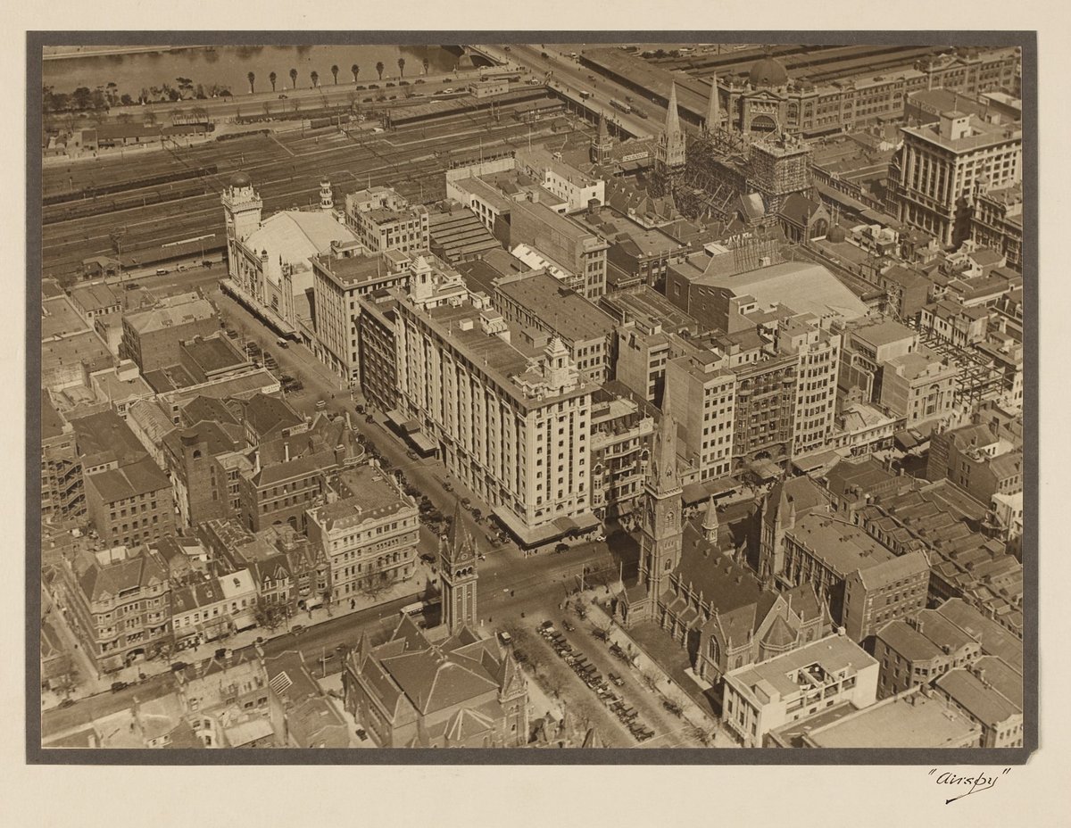 View of the intersection of Russell and Collins Streets looking south-west, showing the spires of St. Paul's under construction, Melbourne City (1927–28)