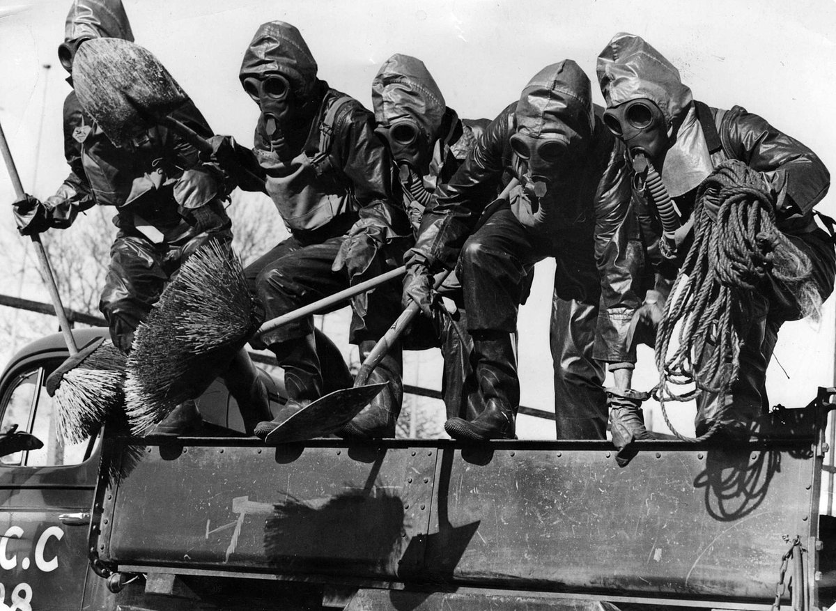 Footscray Council Decontamination Squad jump from truck for practice response to emergency (c. 1940)