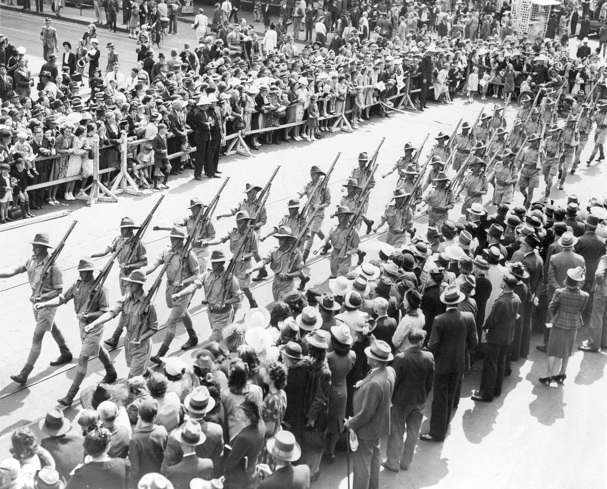 Soldiers marching through Melbourne streets, watched by large crowd, Melbourne City (c. 1941)