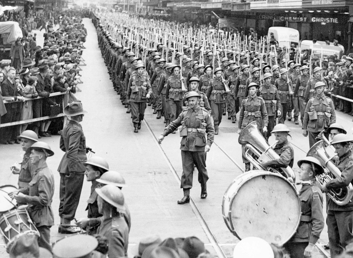 Military band leads marching A.I.F. from Elizabeth Street into Collins Street, Melbourne City (1939–44)