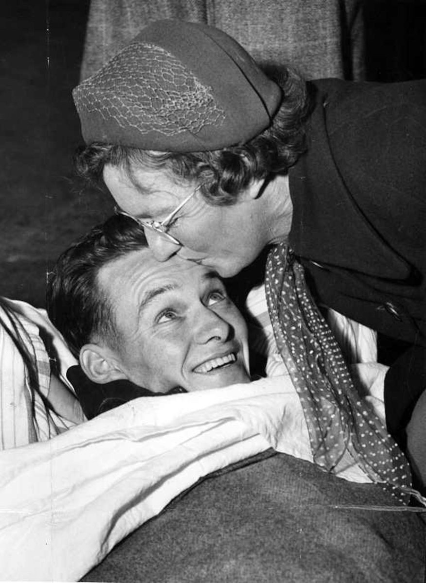 Mother greets son at Essendon (c. 1953)