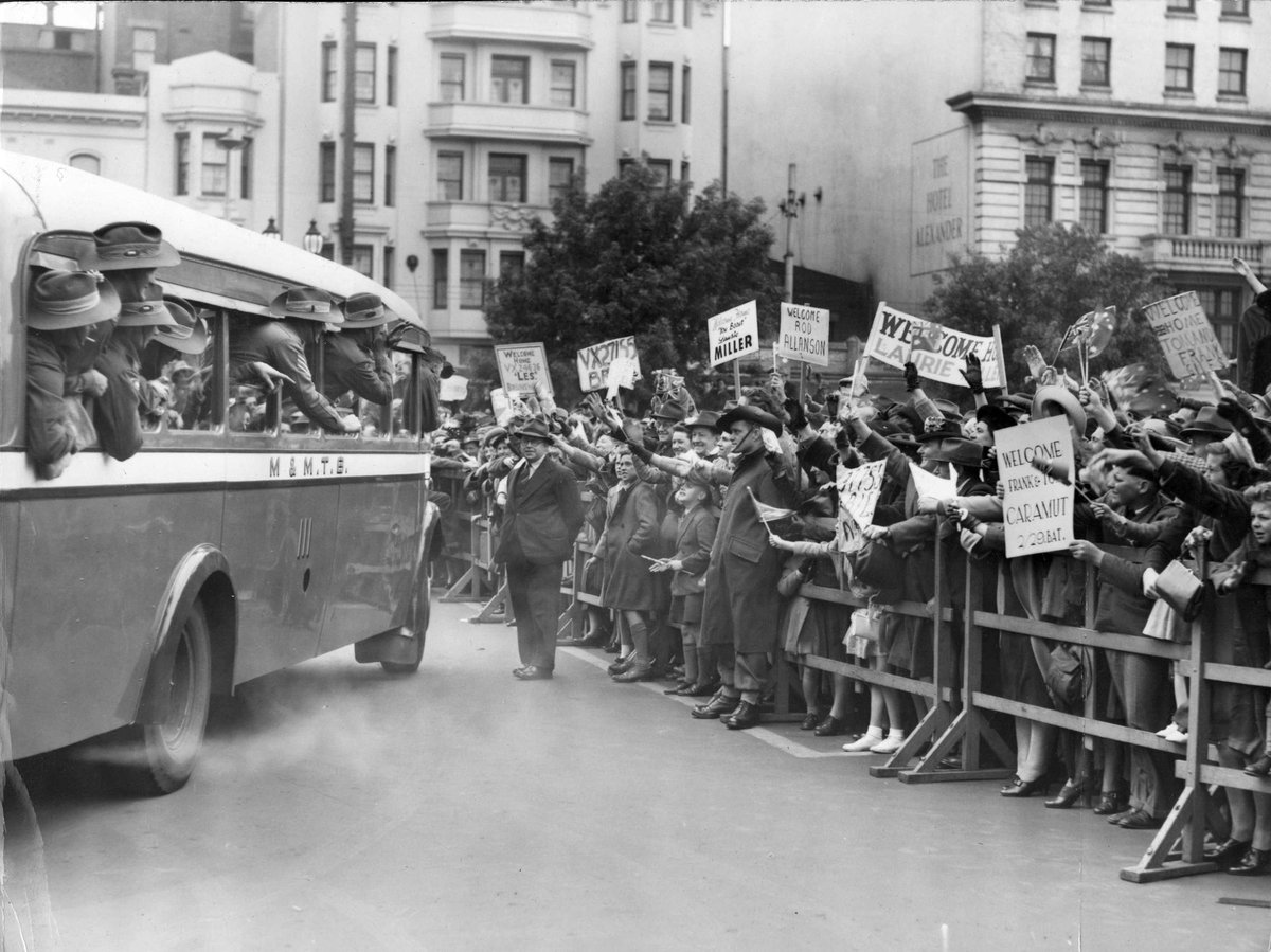 Signs of welcome and personal messages on cardboard are becoming a regular feature at Spencer St. when the boys come home, Melbourne City (c. 1945)