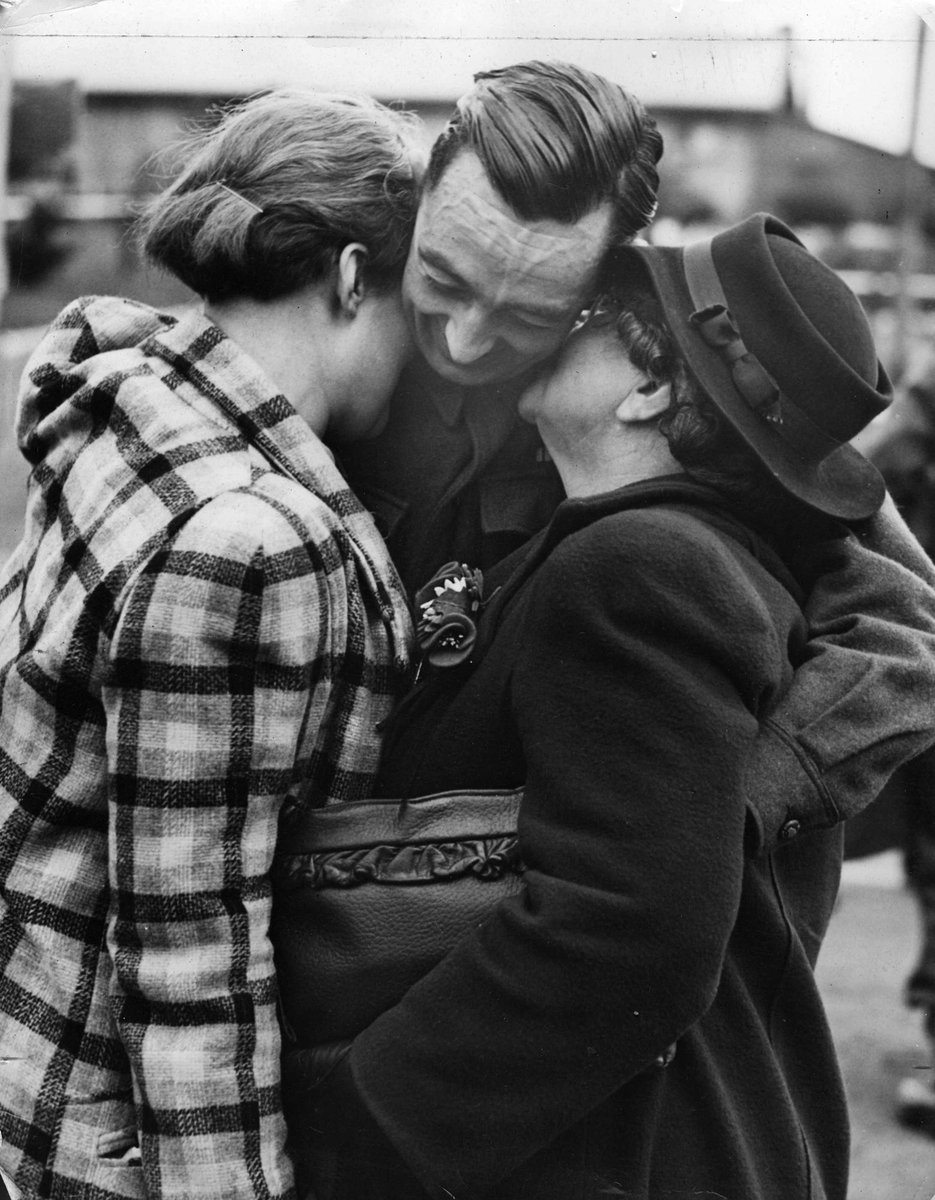 A moving reunion of Pte. George Bennett with his wife and mother-in-law Mrs. A. Gilson at Royal Park, Parkville (c. 1945)