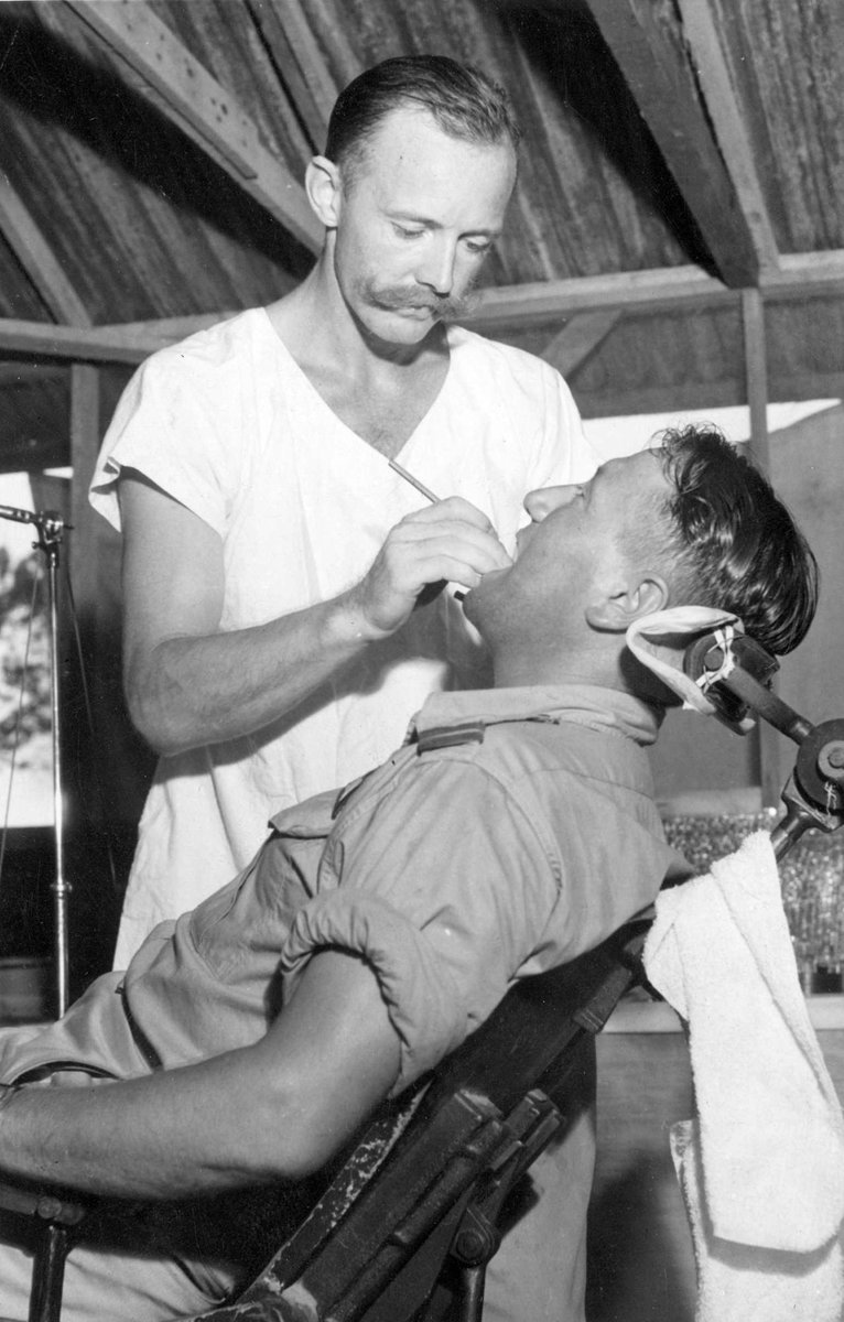 The patient in the dentist chair in the jungle is F/O W. R. Harris of Essendon, (Vic.). The dentist is S/Ldr. R. S. Robinson of Melbourne, (Vic.) (c. 1944)