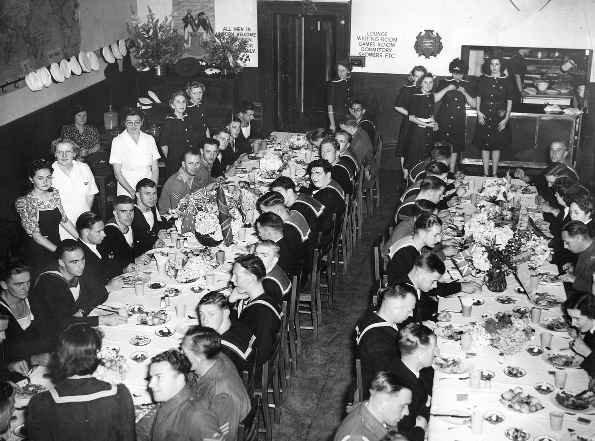 Servicemen and women eating Christmas dinner at Navy House Collins Street, Melbourne City (c. 1944)