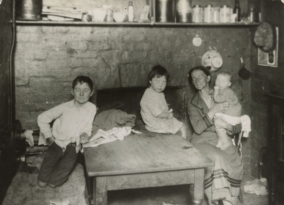 Carlton [Kitchen interior with woman and three children] (c. 1935)