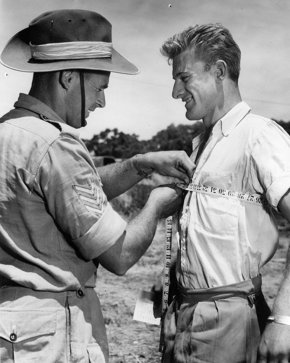 Measuring up for Tunics rather amazes old time soldiers, Sgt. L. Dowsett checks up Fred Dekes of Preston (c. 1952)