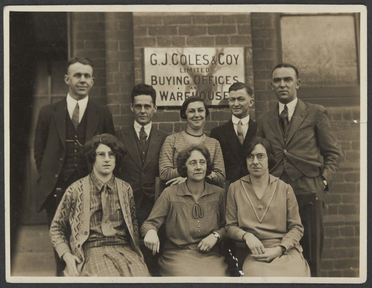 Buying Offices staff four women and four men in two rows front of Collins Street building, Melbourne City (1930–35)