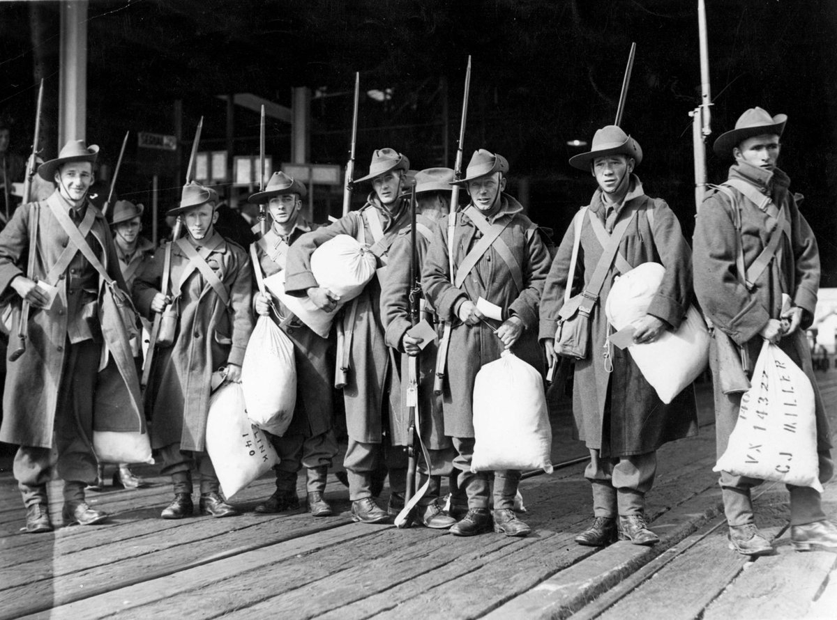 A line of men of the 2nd contingent of the 2nd A.I.F. wait on a deck to embark at Port Melbourne (1937–43)