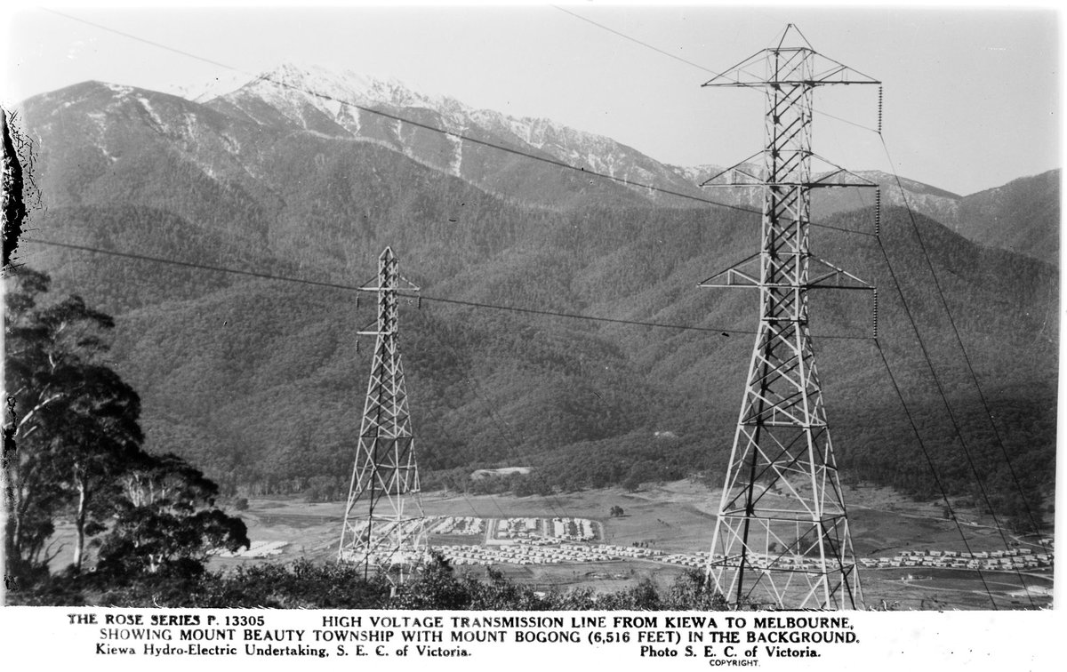 HIGH VOLTAGE TRANSMISSION LINE FROM KIEWA TO MELBOURNE, SHOWING MOUNT BEAUTY TOWNSHIP WITH MOUNT BOGONG (6,516 FEET) IN THE BACKGROUND (1920–54)