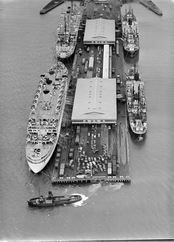 Four ships at pier in Port of Melbourne, one possibly preparing to depart, c. 1928