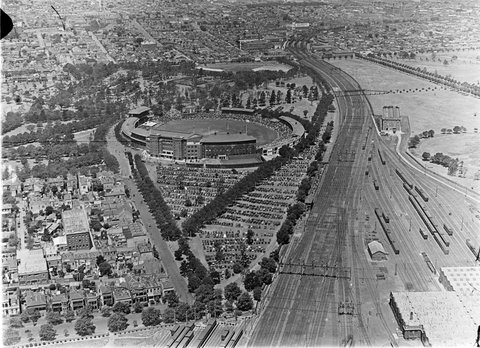 Melbourne Cricket Ground (MCG) showing crowd at ground, parked cars and railway lines, 1925–35