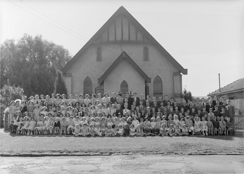 Large group of men, women and children outside Church of Christ, Berry Street, North Essendon, 1951?