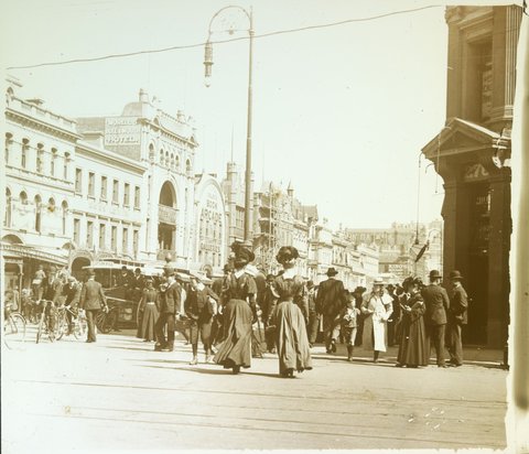 Pedestrians crossing street at intersection of Bourke and Swanston Streets, Melbourne, 1880–1938