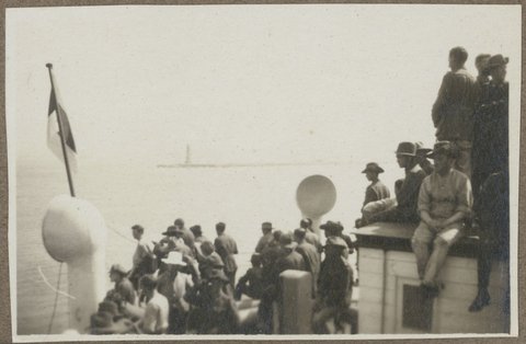 Soldiers crowding the deck of the Chemnitz, enroute to Melbourne from Europe, lighthouse in the distance, 1919