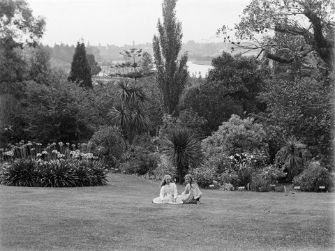 View of Botanical Gardens (Melbourne?), with two young girls seated on the grass, 1900–20