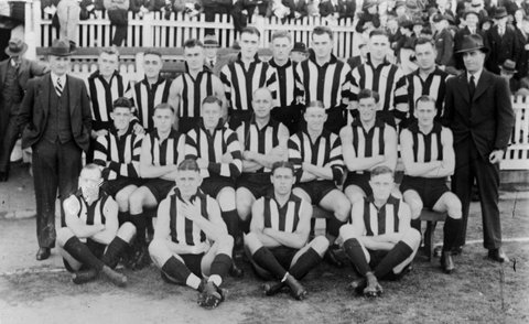 Collingwood (VFL) First Eighteen in front of a grandstand, c. 1934