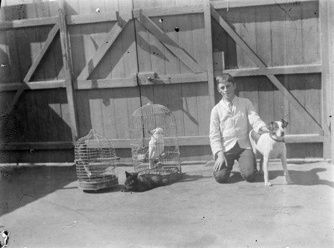 John Henry Bishop's cousin in the backyard at Footscray with the family pets, 1917