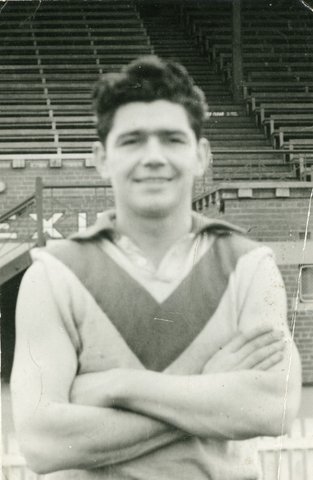 Ron Clegg, South Melbourne football player, standing on field, 1949–51