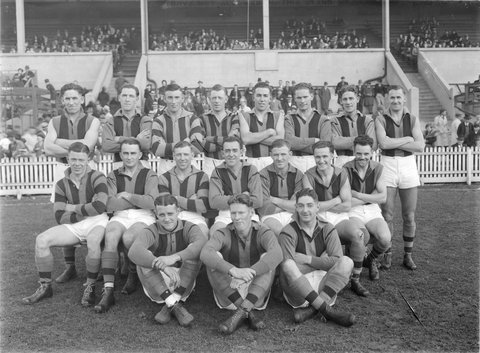 Port Melbourne senior football team in front of a grandstand, 1938–39