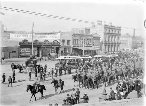 Street scene, possibly Elizabeth Street, Melbourne, with military cavalry parade in progress, 1890–1920