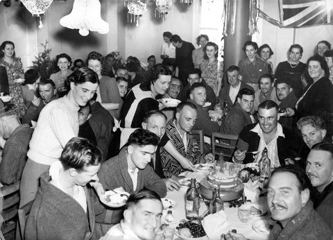 Christmas treat for the men of 3E at Heidelberg Military Hospital supplied by the girls of B shift of Dominion Can Co. Annex. These girls go out to this hospital each week with flowers & amenities, 1940–45