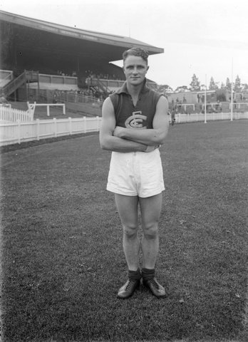 [Carlton Football player Ron "Socks" Cooper in front of grandstand], 1932–42