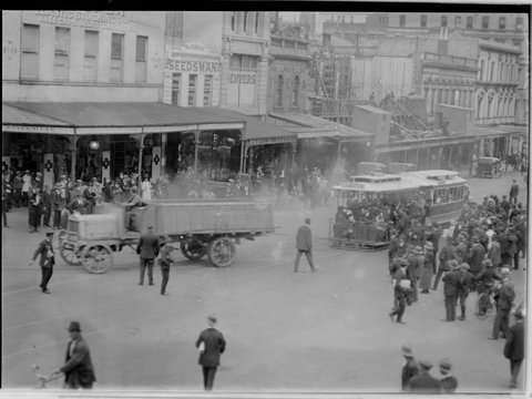 Procession of truck in front of North Carlton tram being watched by a large group of people, 1902–20