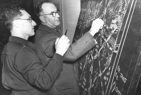 V.D.C. (Metropolitan Group) at drill hall, George St Fitzroy...work out manoeuvres on the maping board, c. 1942