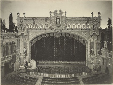 View of proscenium with two organs either side of the orchestra pit and a grand piano at left at State Theatre Melbourne, 1929
