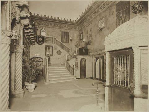 View towards stairs to dress circle from the entrance foyer of the State Theatre Melbourne, showing gargoyles along underside of the balcony, 1929