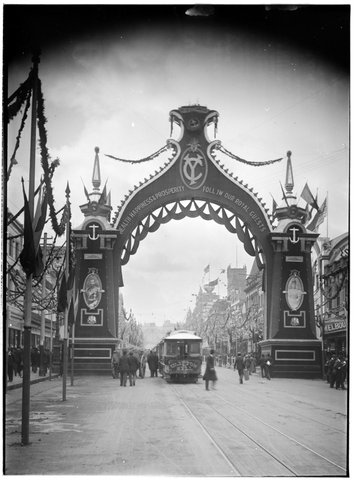 Arch across Bourke Street, with the words Health Happiness & Prosperity Follow Our Royal Guests, c. 1901