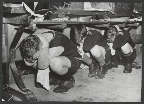 Brighton Technical School Boys crouch under their desks, c. 1942